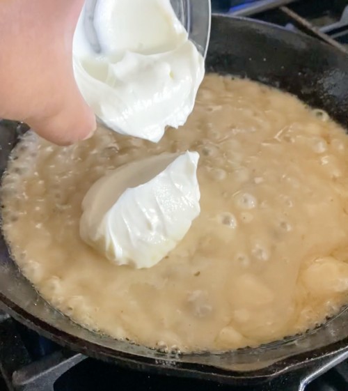 Adding sour cream to bubbling condensed mushroom soup (in skillet).