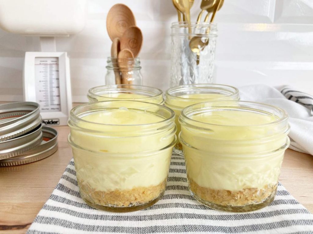 Baked cheesecake in mason jars cooling.