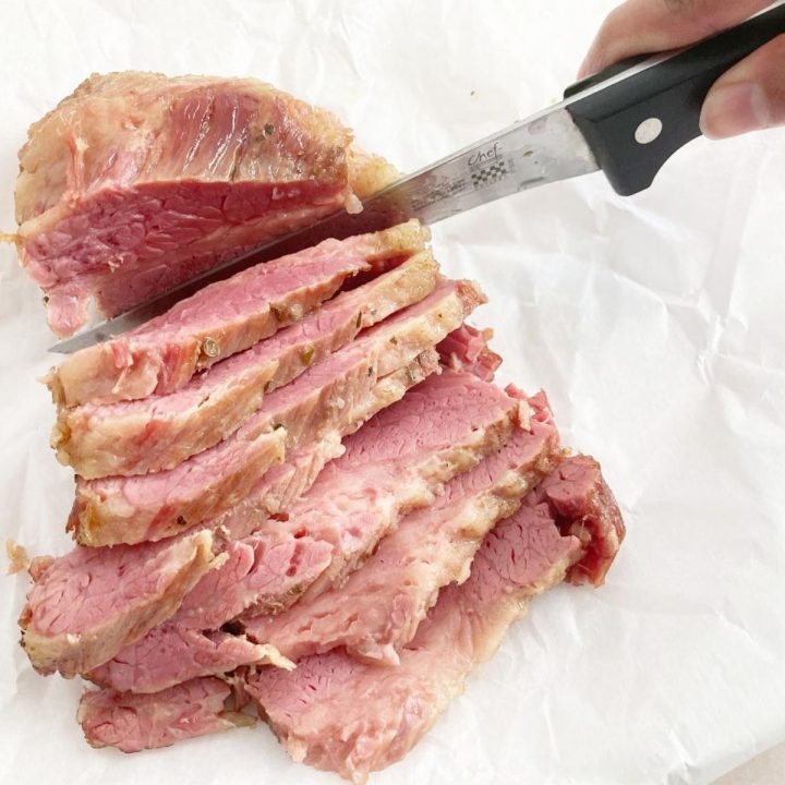Slicing deli-style cornbeef with knife. Thick slices.
