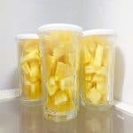 Pineapple stored in glass jars in the fridge.