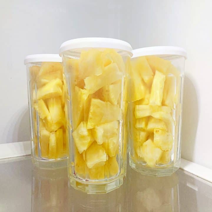 Pineapple stored in glass jars in the fridge.