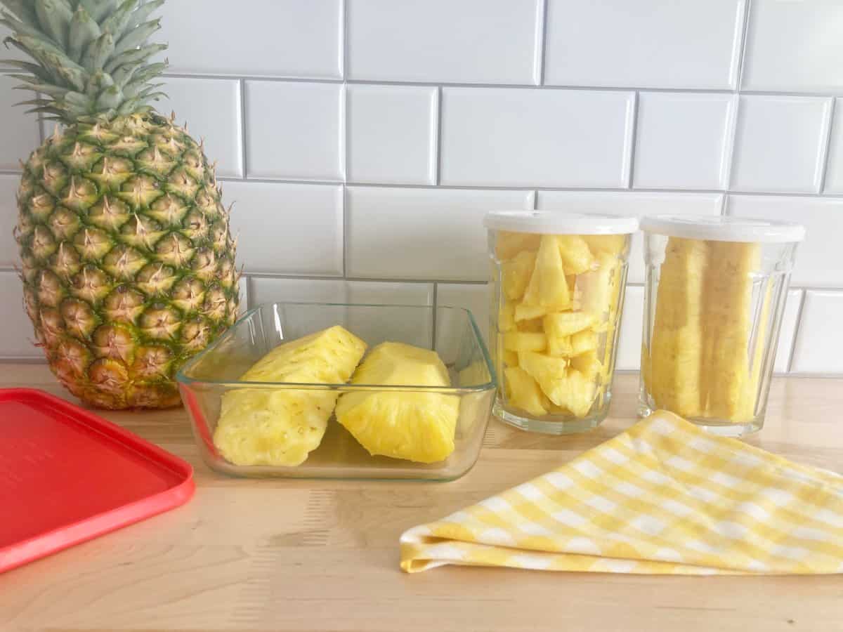 Fresh Pineapple uncut and cut stored in glass jars and containers.