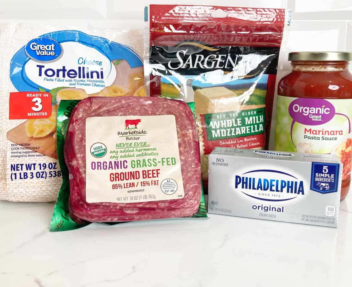 All five ingredients in their packages. Frozen tortellini, jar of pasta sauce, shredded mozzarella, one pound of 85/15 ground beef and one block of Philadelphia cream cheese.