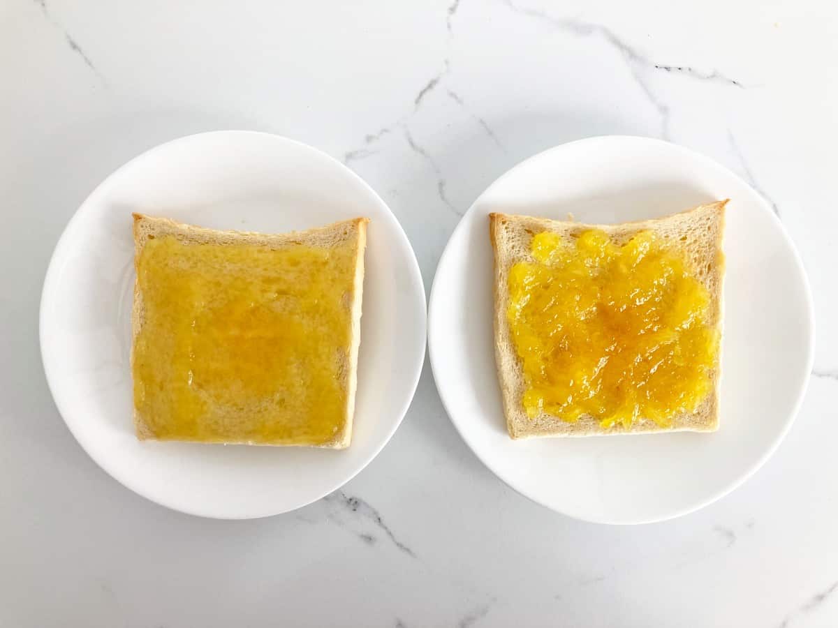 Two slices of toast on white plates. One on the left with pineapple jam and one on the right with pineapple preserves.