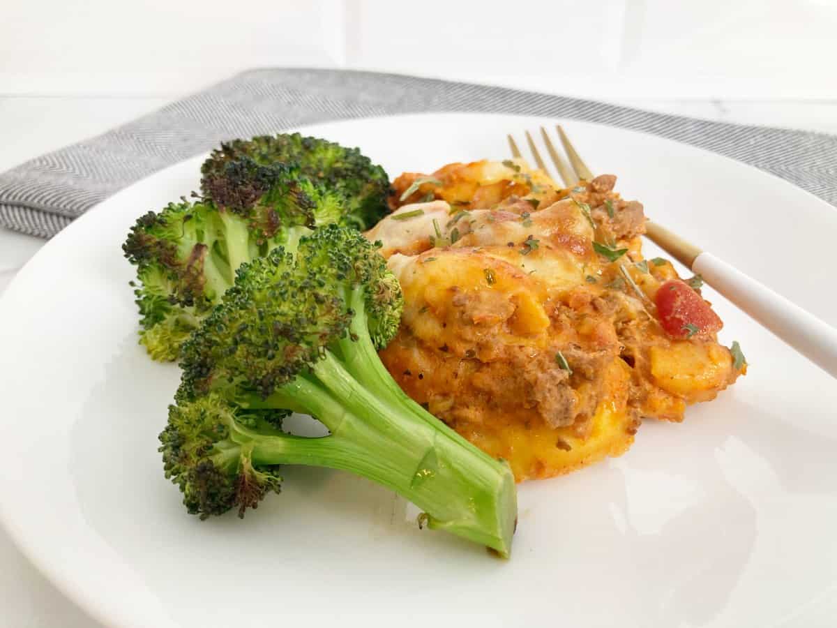 A serving of the TikTok cheesy tortellini bake served with oven-roasted broccoli.