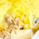 Spoon holding white chicken chili cornbread casserole with jiffy mix.