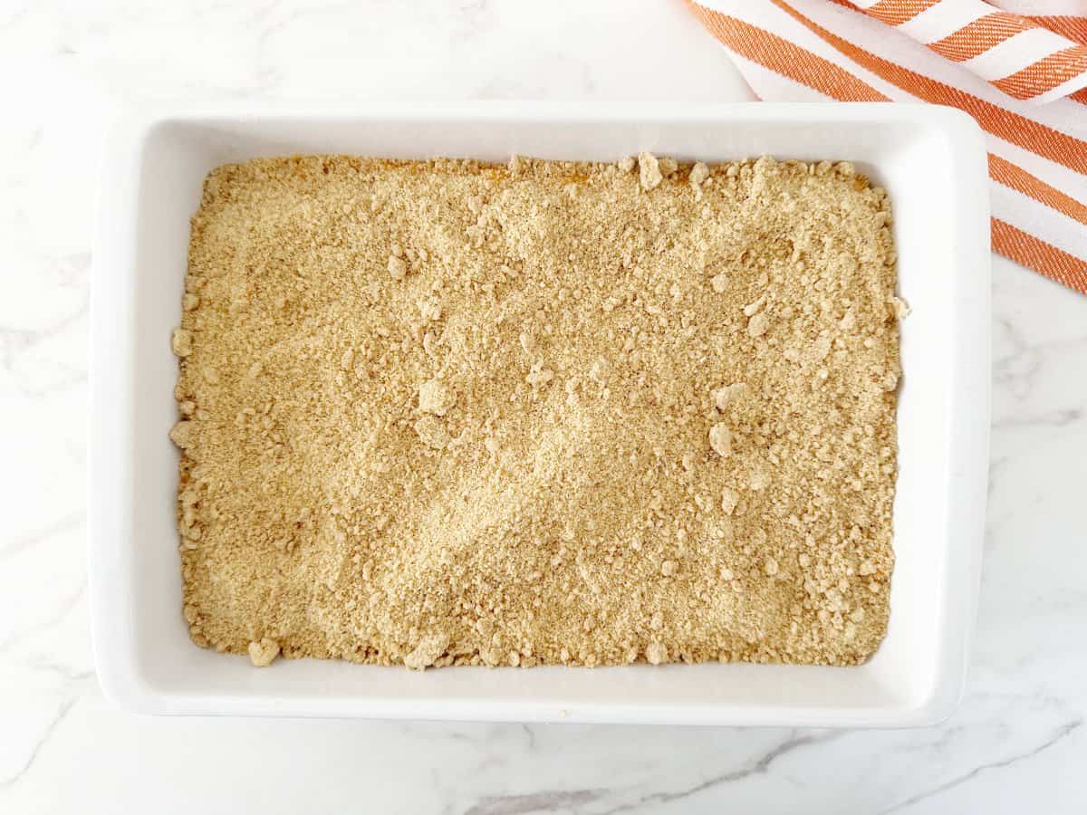 Down view of sweet potato mixture and crumble in white baking pan.