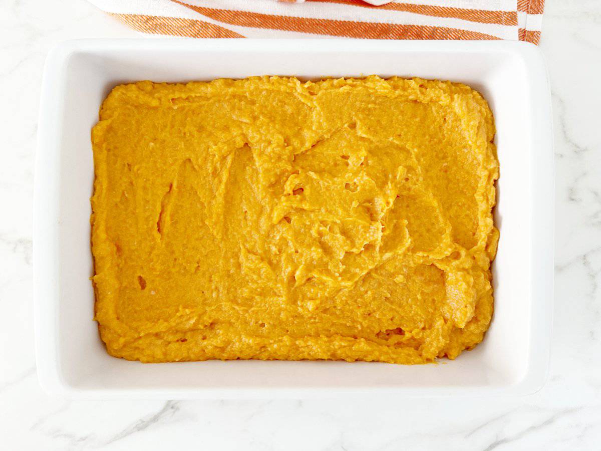 Down view of sweet potato mixture in white baking pan.