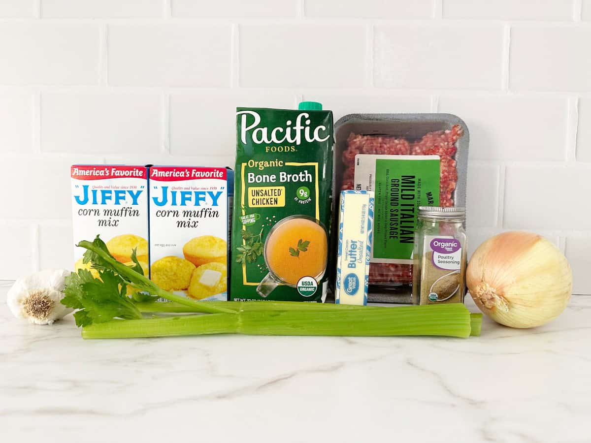 Side view of ingredients for jiffy cornbread stuffing muffin in their packaging and uncut vegetables.