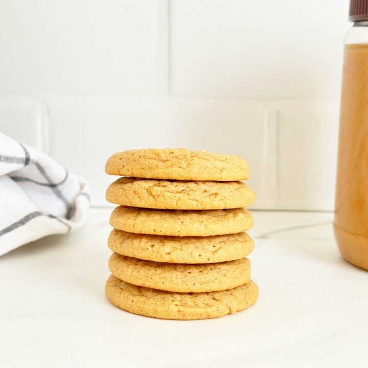 Seven stacked soft and chewy peanut butter cookies.