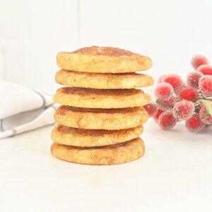 Seven stacked soft and chewy snickerdoodle cookies.