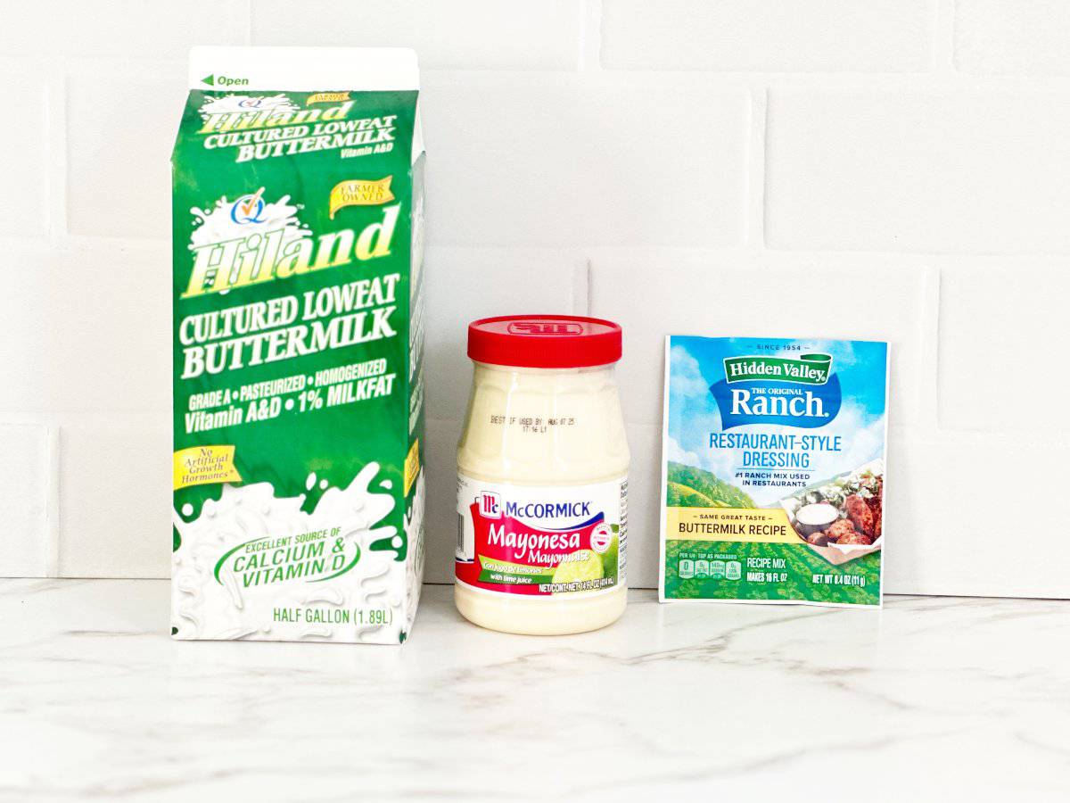 Side view of ranch dressing ingredients. Carton of buttermilk, jar of McCormick Mayonesa, and packet of Hidden Valley Restaurant Style Ranch.