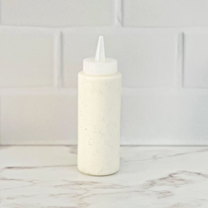 Side view of the restaurant style ranch dressing in a squeeze bottle.