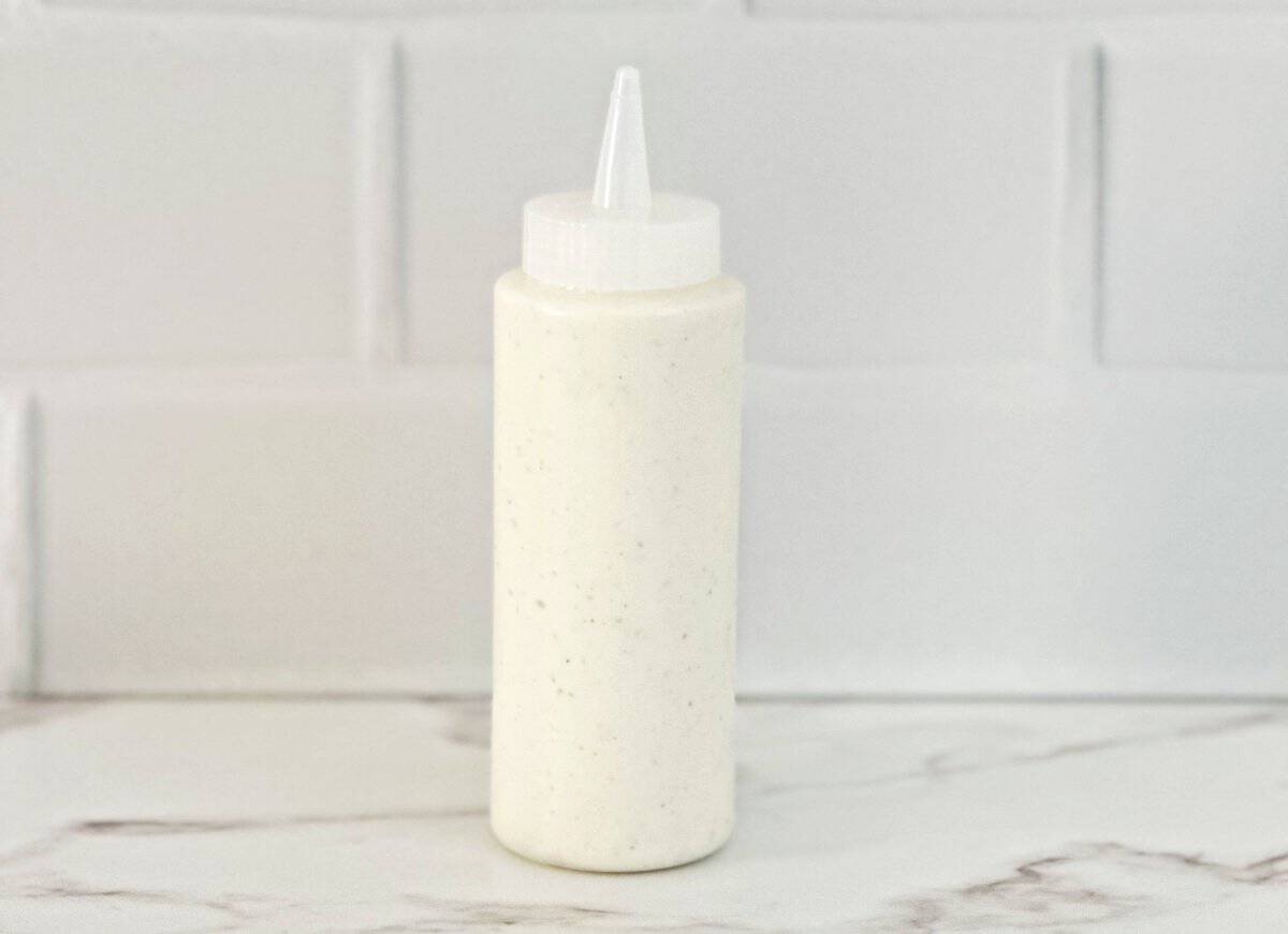 Side view of the restaurant style ranch dressing in a squeeze bottle.