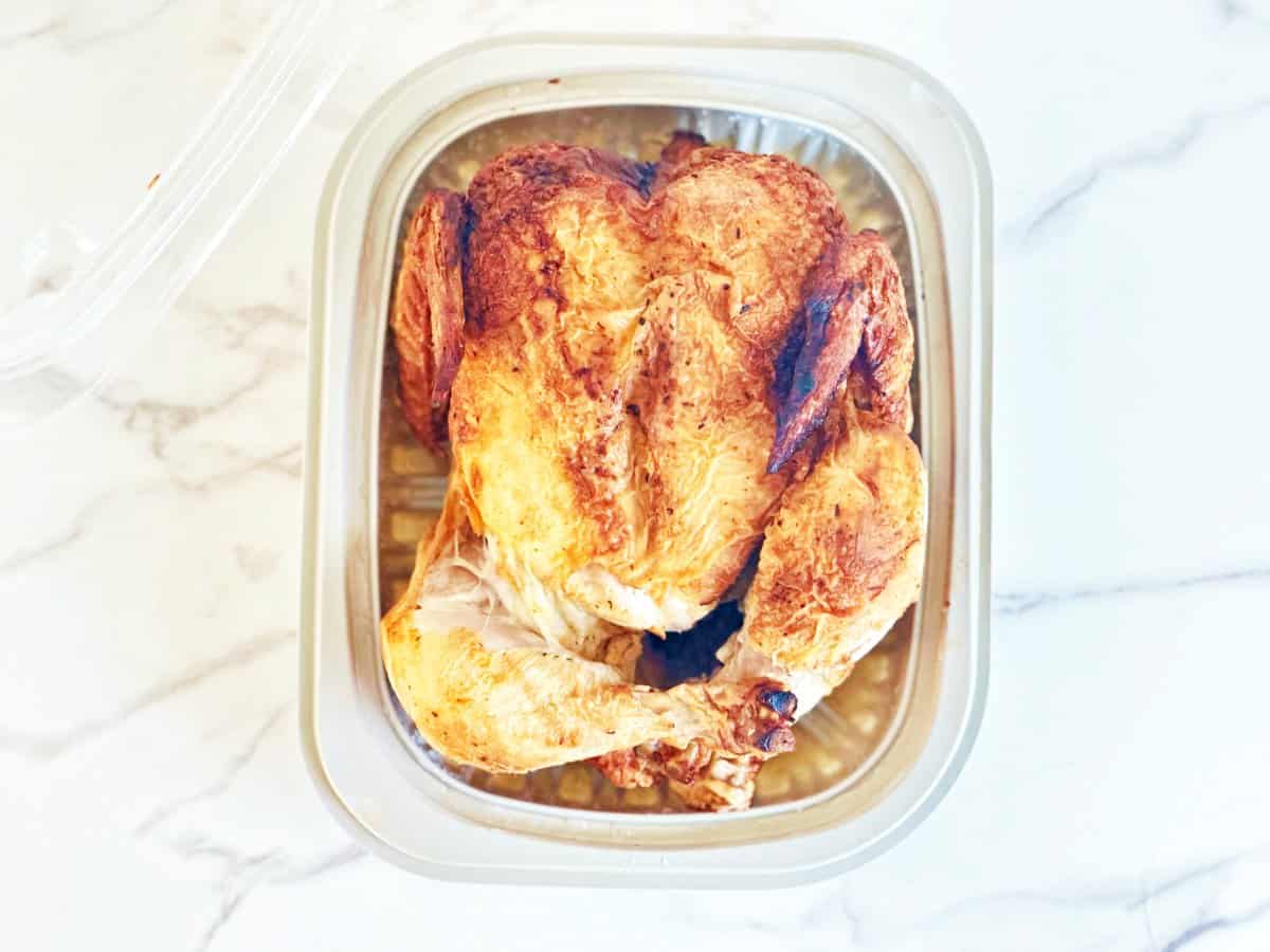 Store bought rotisserie chicken in plastic container.
