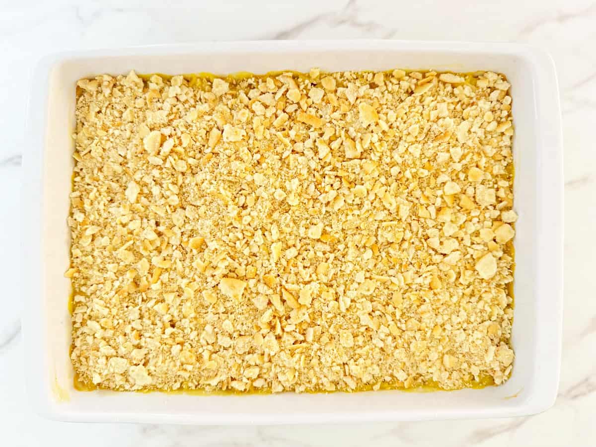 Down view white baking dish with ritz cracker topped casserole.
