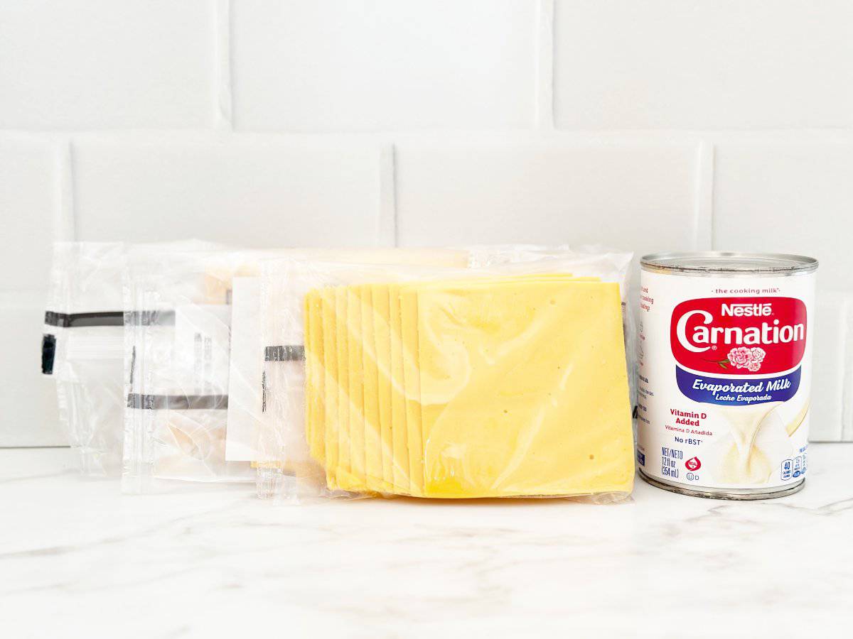 Side view of can of evaporated milk and sliced American cheese.
