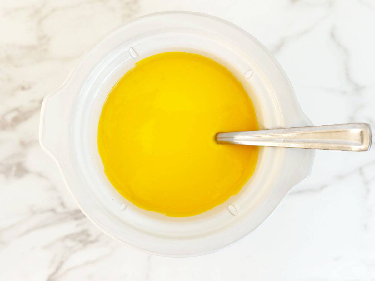 Down view of smooth cheese sauce in crockpot.