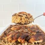 Serving spoon holding stick of butter rice and chicken.