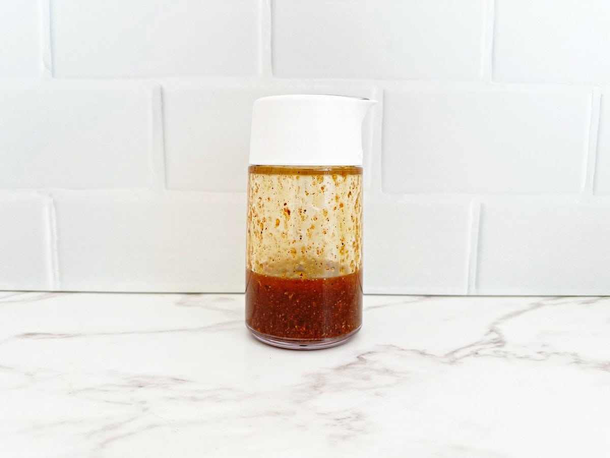 White and clear dressing bottle with taco vinaigrette.