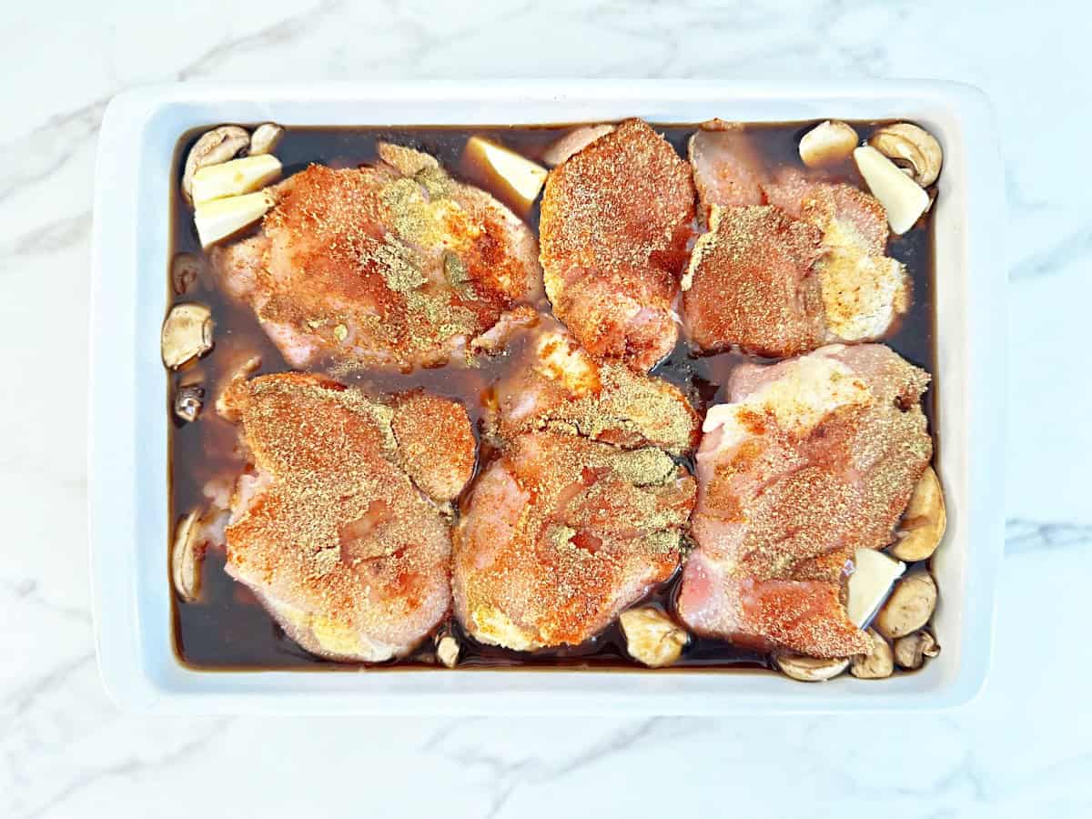 Down view white baking dish with unbaked casserole.