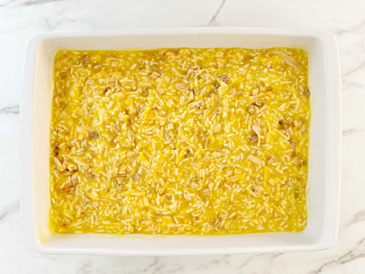 Down view white baking dish with unbaked casserole.