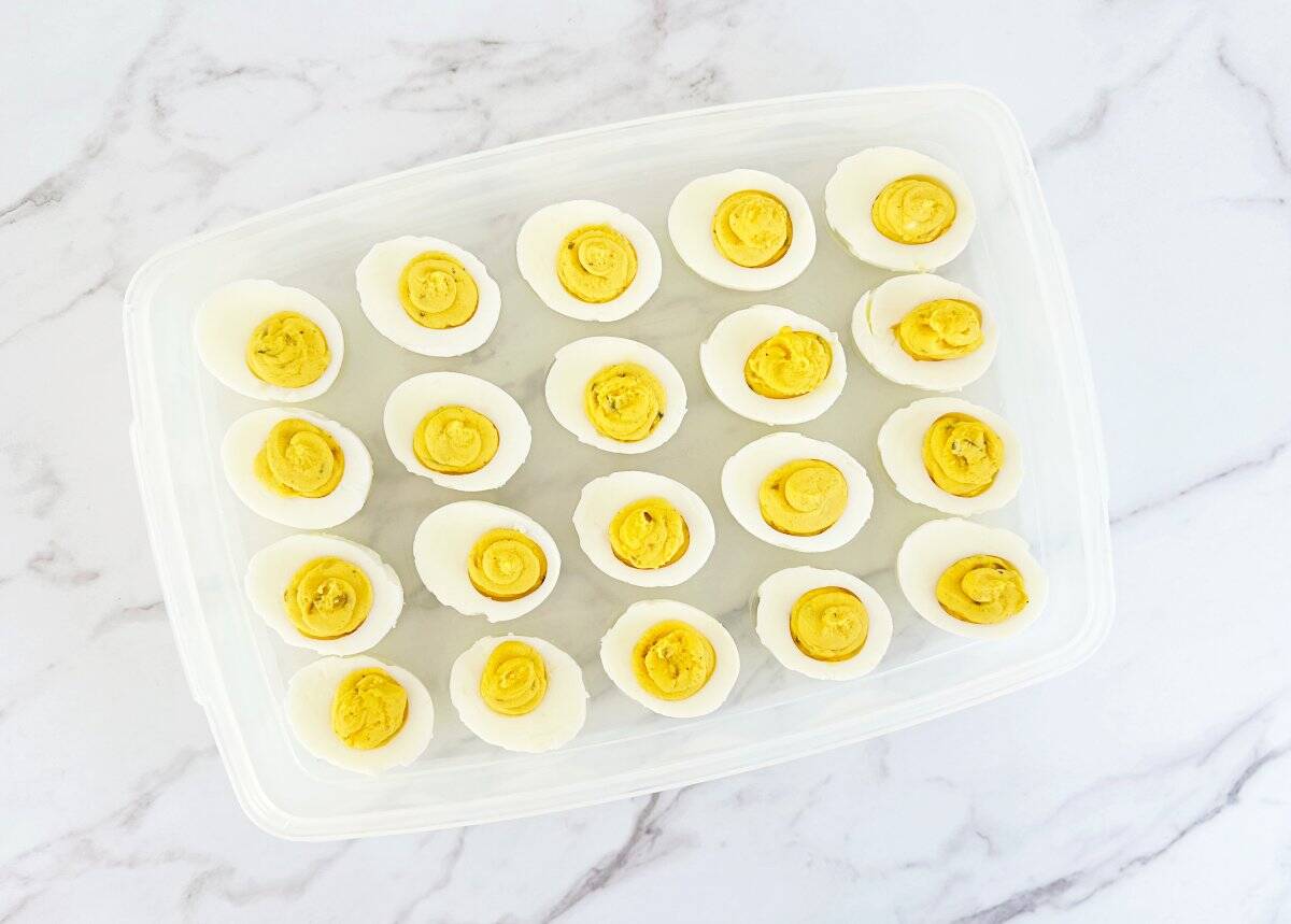 Down view of easy deviled eggs in plastic deviled egg container.