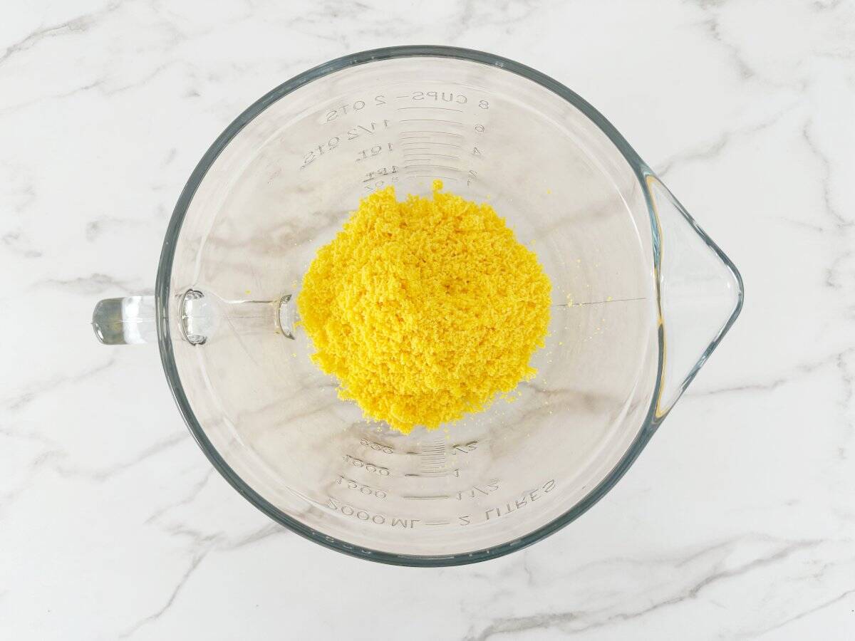 Down view of a glass mixing bowl with smooth egg yolks.