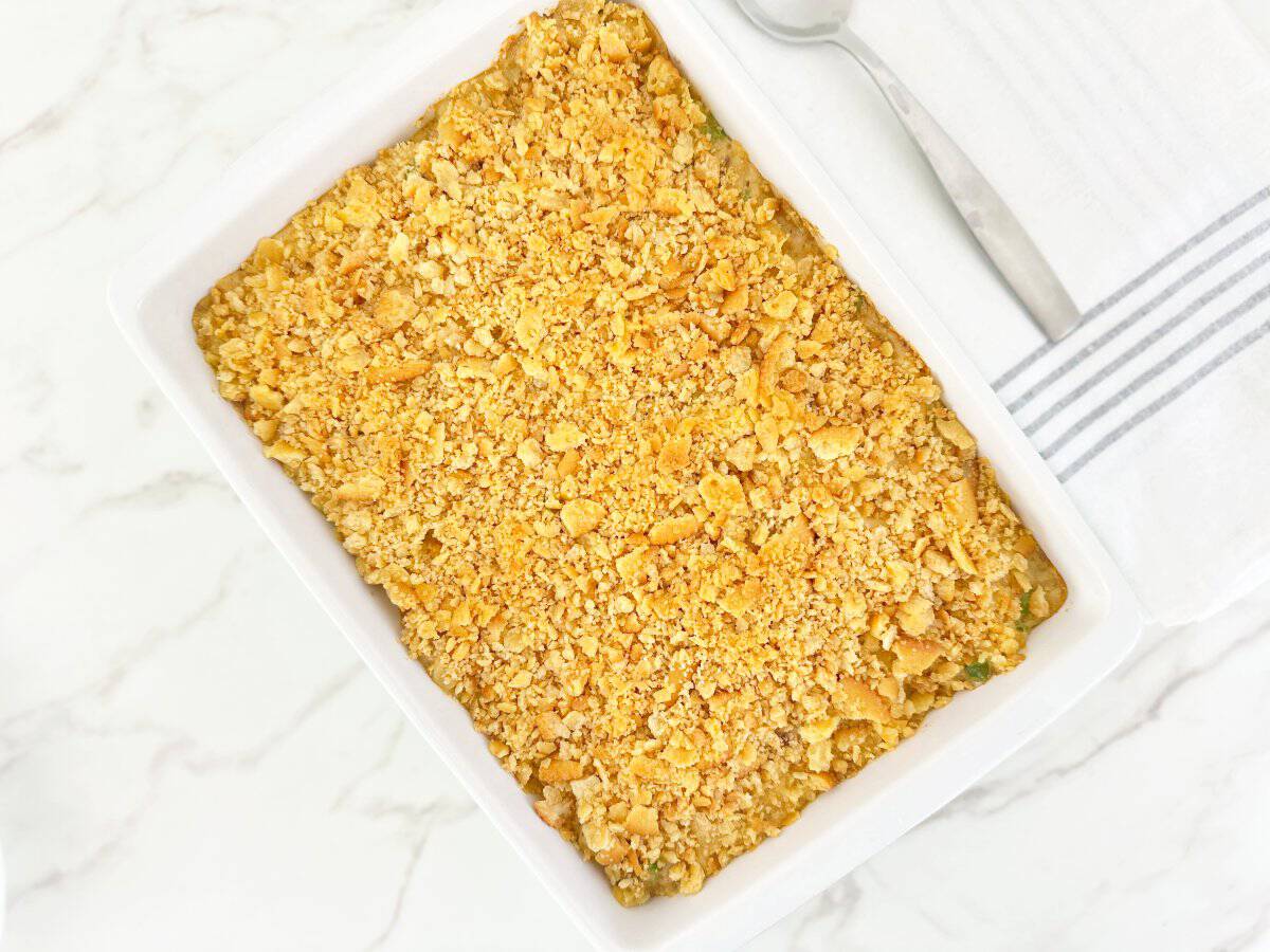 Down view oven baked tuna noodle casserole in white baking dish.