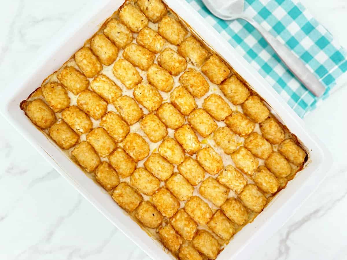 Down view oven tater tot chicken pot pie casserole in white baking dish.