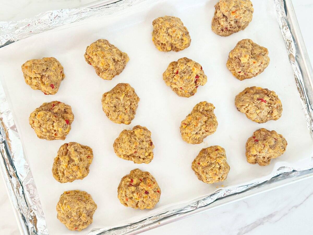 Down view of baked pimento cheese balls on sheet pan.