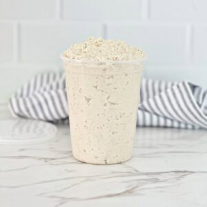 Side view of deli chicken salad in plastic container.