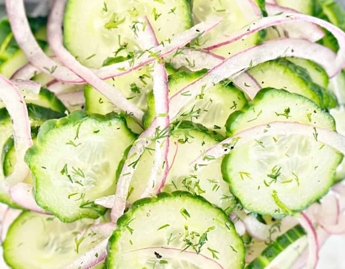 Close up view of vinegar cucumber salad with fresh dill.