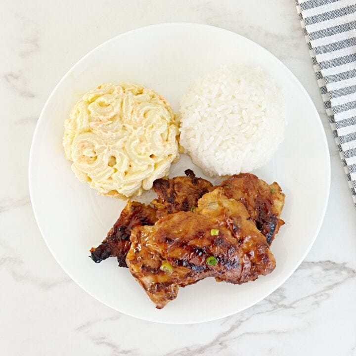 Down view of Hawaiian chicken bbq plate. Side of Mac salad, white rice, and grilled chicken thighs.