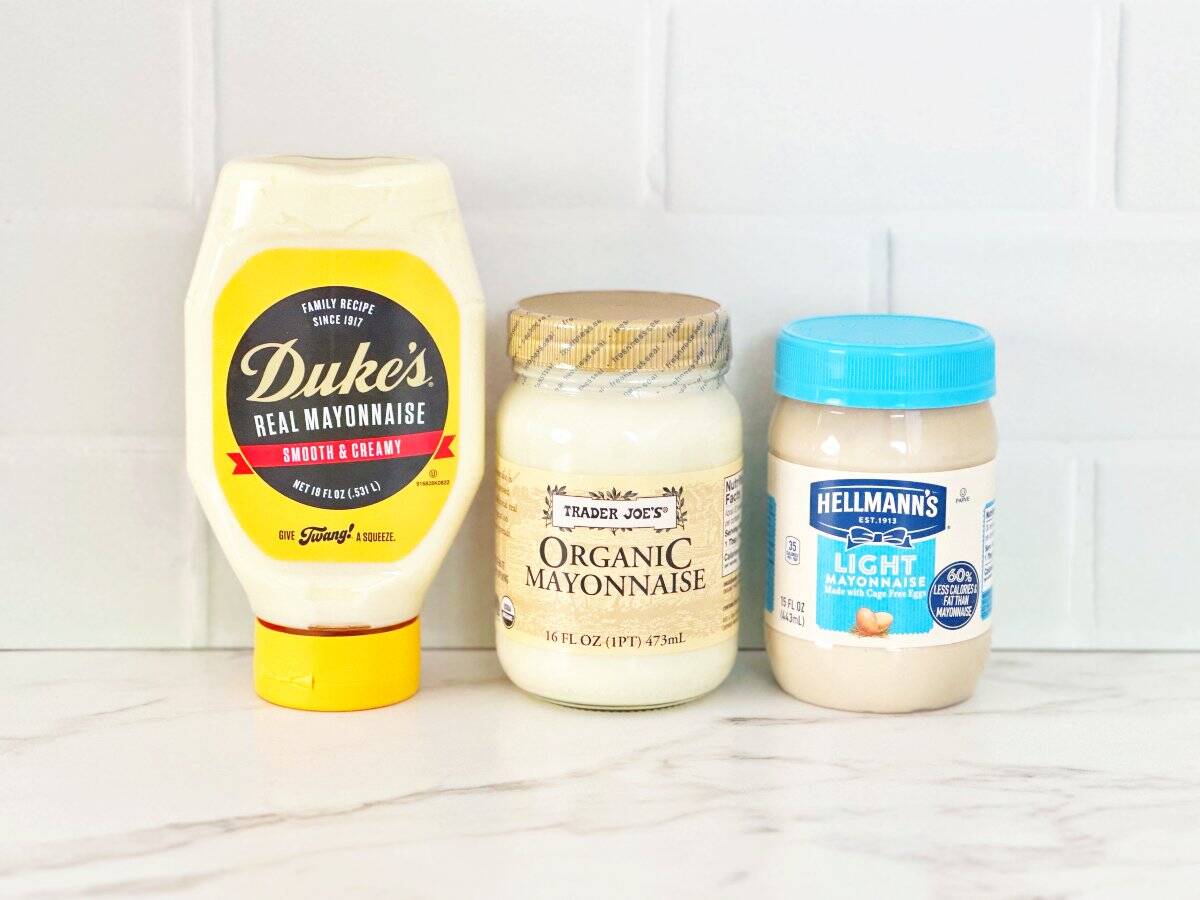 Side view of 3 brands of mayo. Hellman's Light Mayo, Duke's, and Trader Joes Organic.