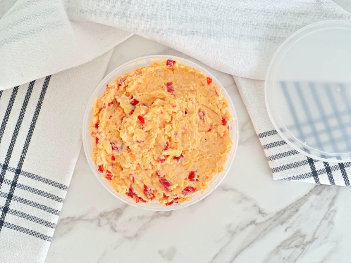 Down view of pimento cheese in deli container.
