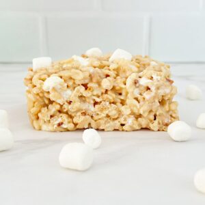 Condensed milk rice krispies treats surrounded by mini marshmallows.
