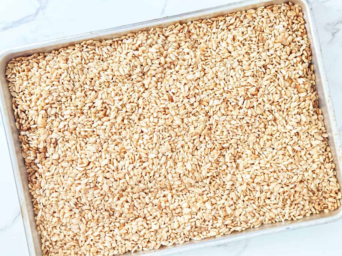 A sheet pan with toasted rice krispies cereal.