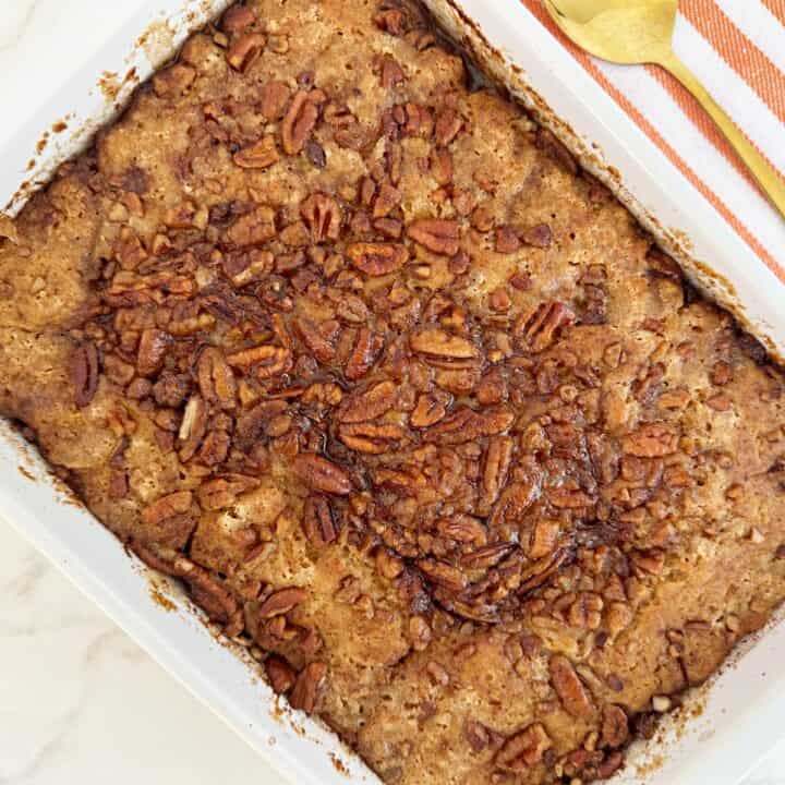 Easy sweet potato pecan cobbler in a white baking dish.
