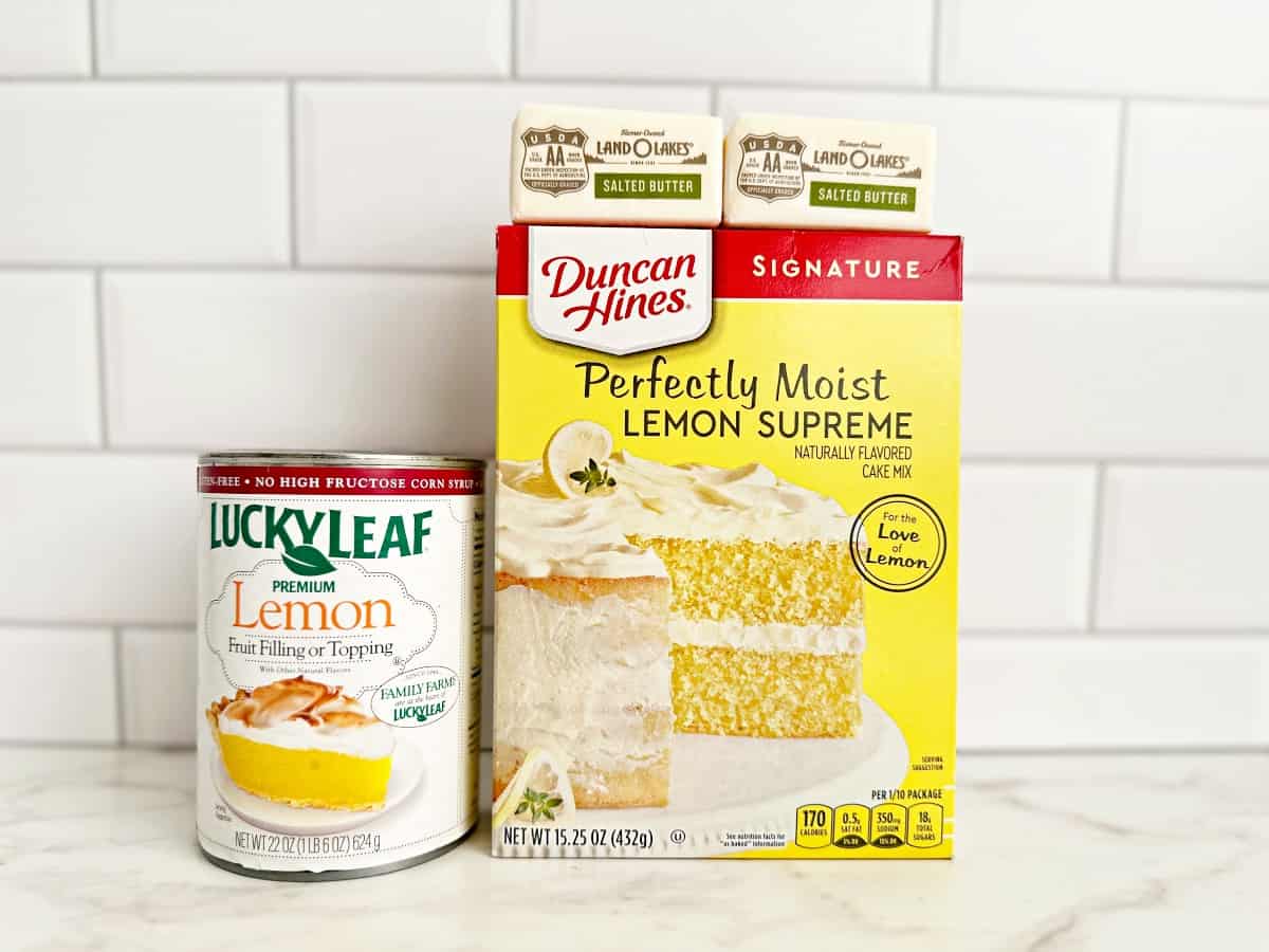 Box of lemon cake mix, stick of butter, and canned lemon pie filling.