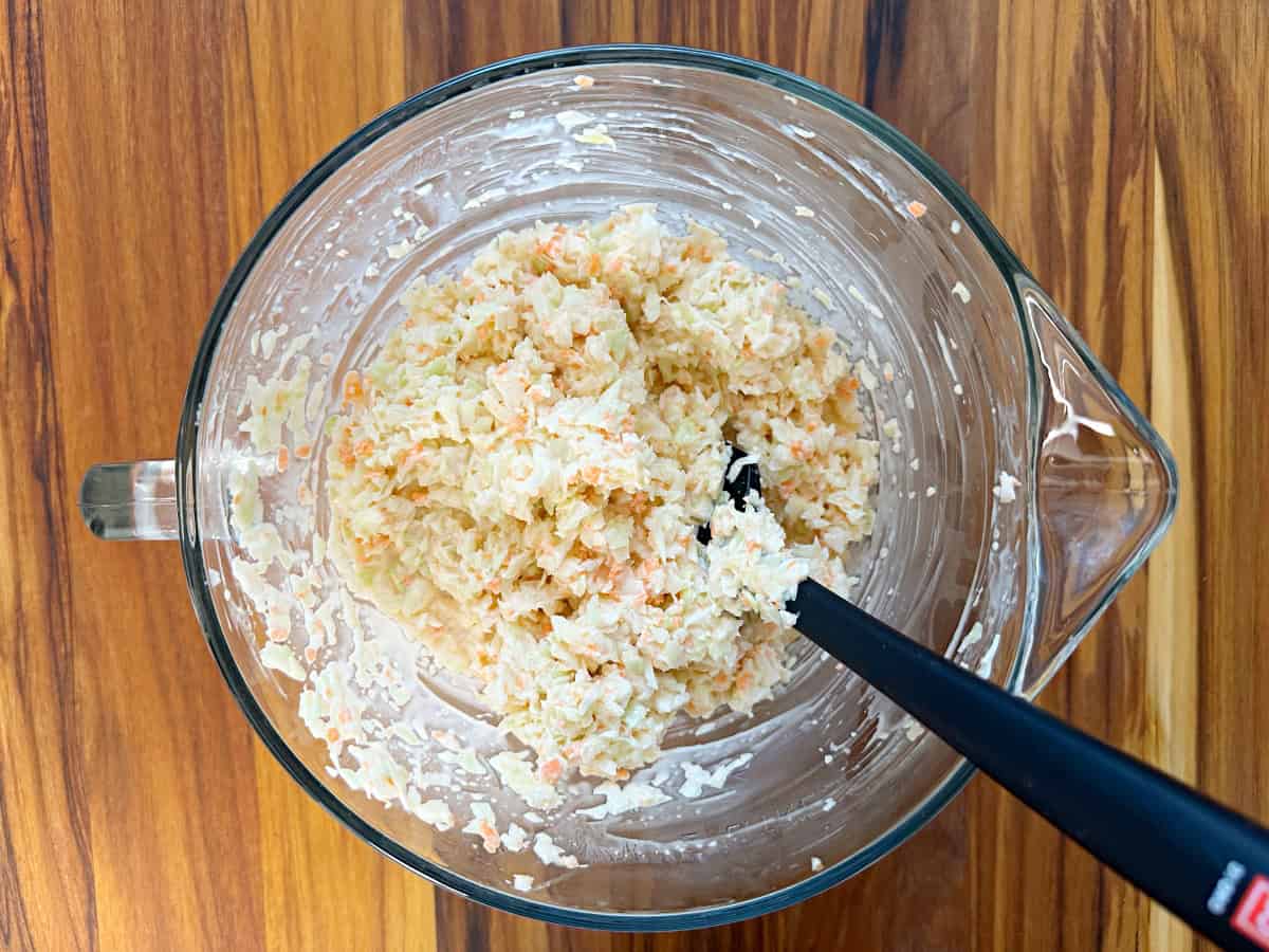 Down view of a glass bowl with mixed coleslaw.