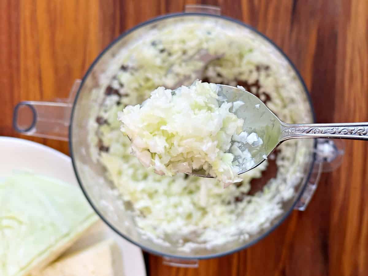 Down view of silver spoon with shredded cabbage.