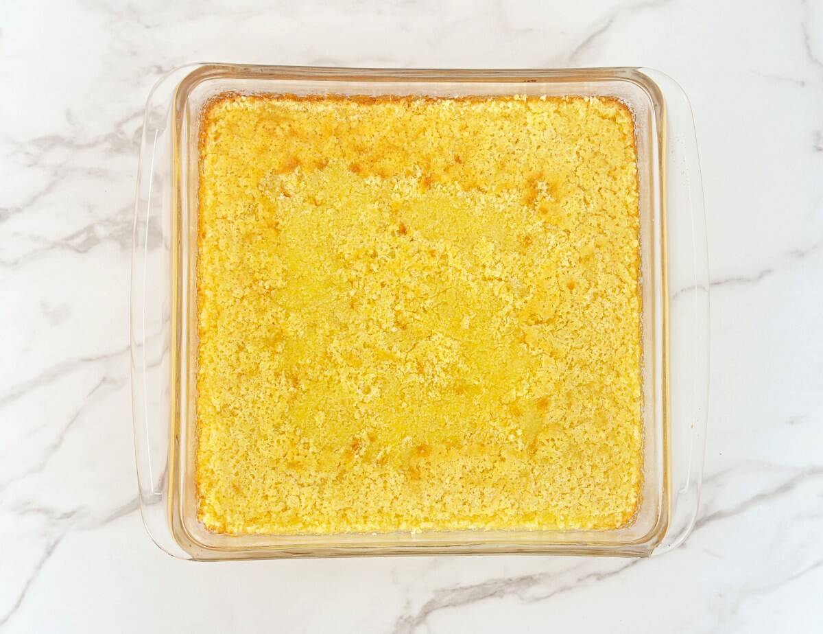Baked cornbread in a glass baking dish, down view.