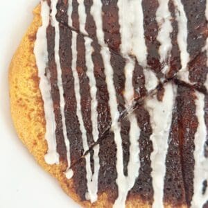 Cinnamon sugar dessert pizza on a white plate, close up down view.