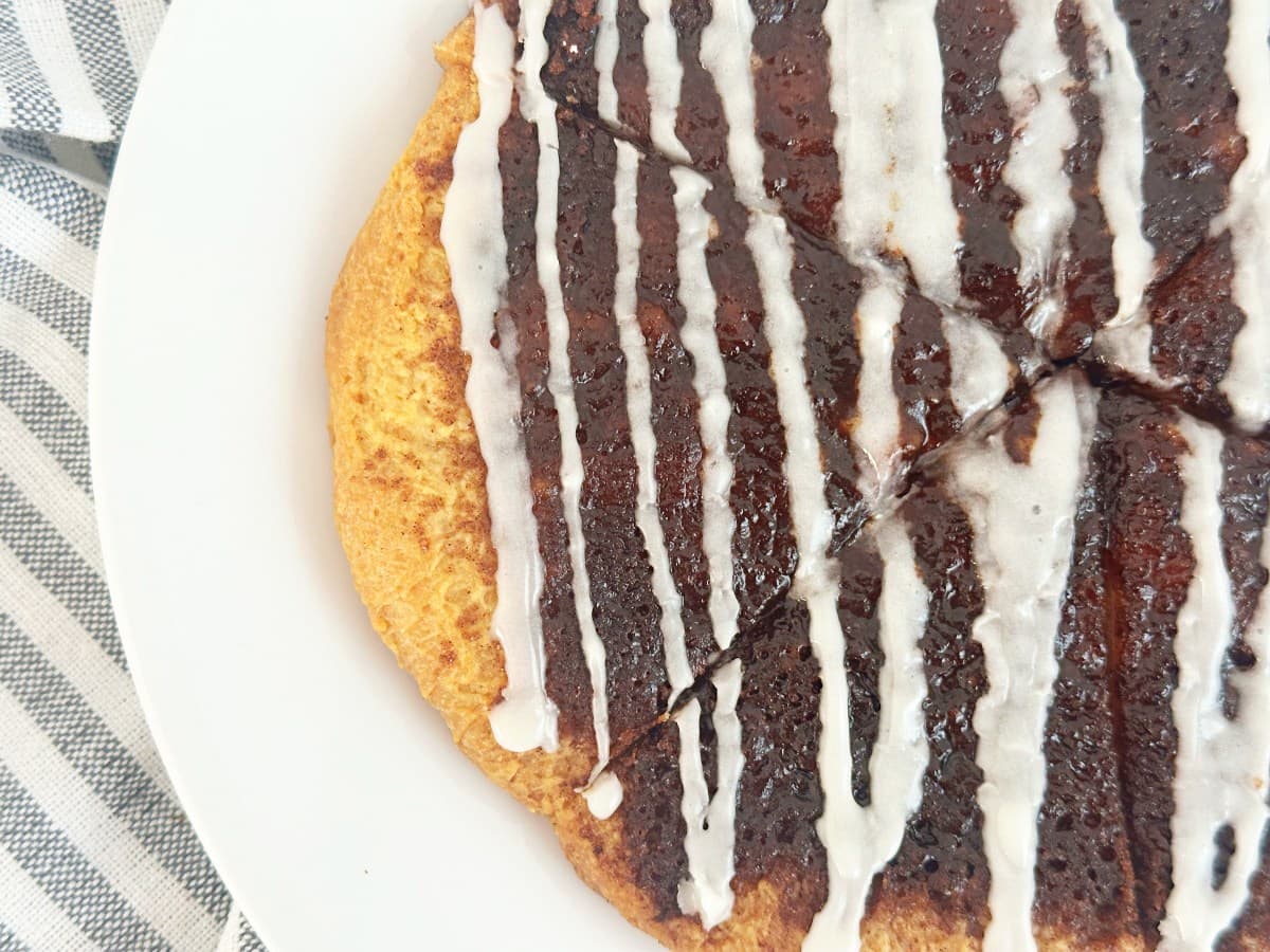 Cinnamon sugar dessert pizza on a white plate, close up down view.