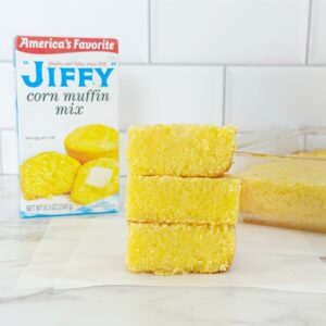 Three Jiffy buttermilk cornbread pieces stacked, side view.