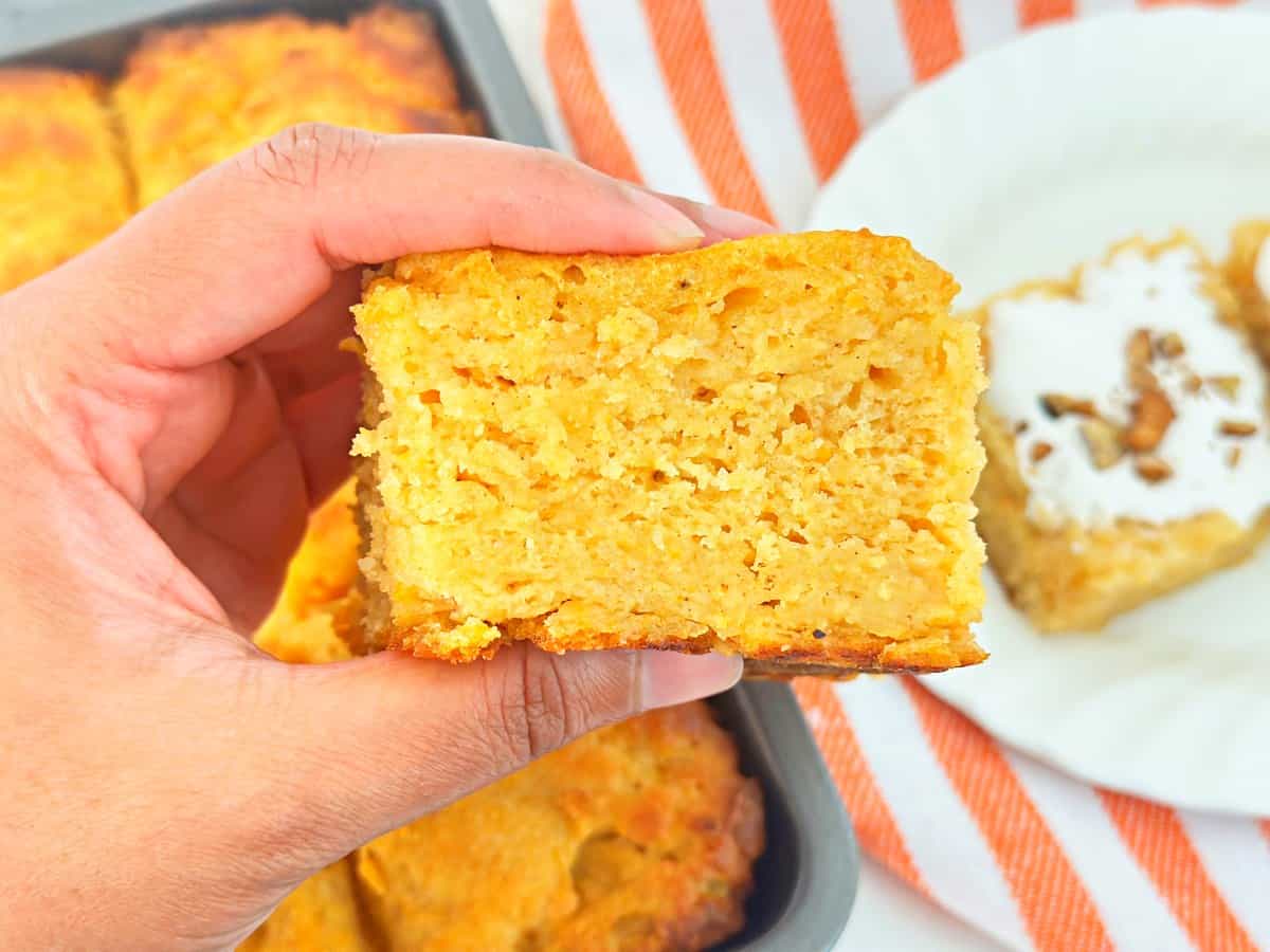Hand holding a moist and fluffy sweet potato butter swim biscuit.