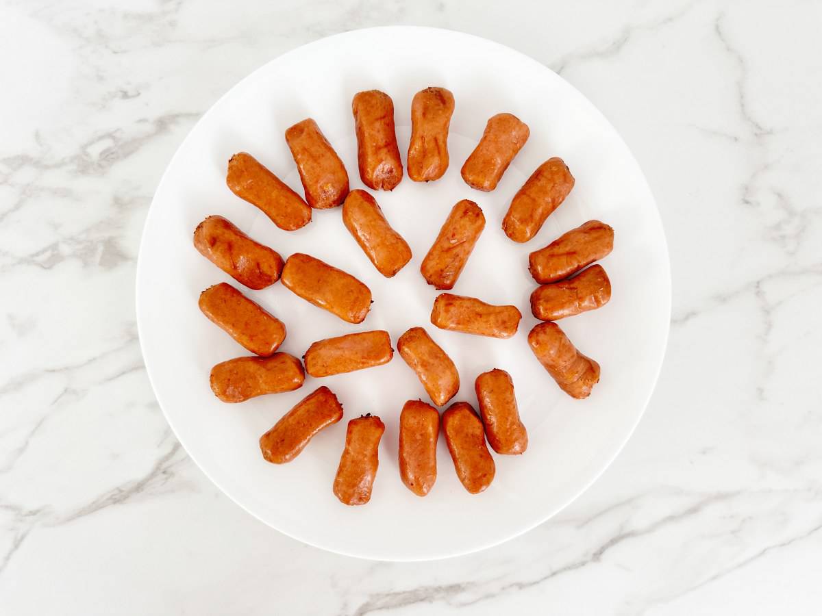 White plate with lit'l smokies, down view.