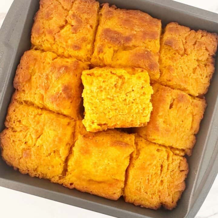 Pumpkin butter swim biscuits in a metal baking pan. Close-up view to show moist and fluffy texture.